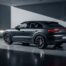 Porsche Cayenne Coupé gris foncé garée dans un garage moderne, vue trois-quarts arrière montrant la ligne de toit plongeante