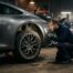 Inspection minutieuse d une Porsche 992 grise en garage avant achat d occasion