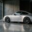 Porsche 911 type 997 argent vue de trois-quarts arrière dans un garage moderne